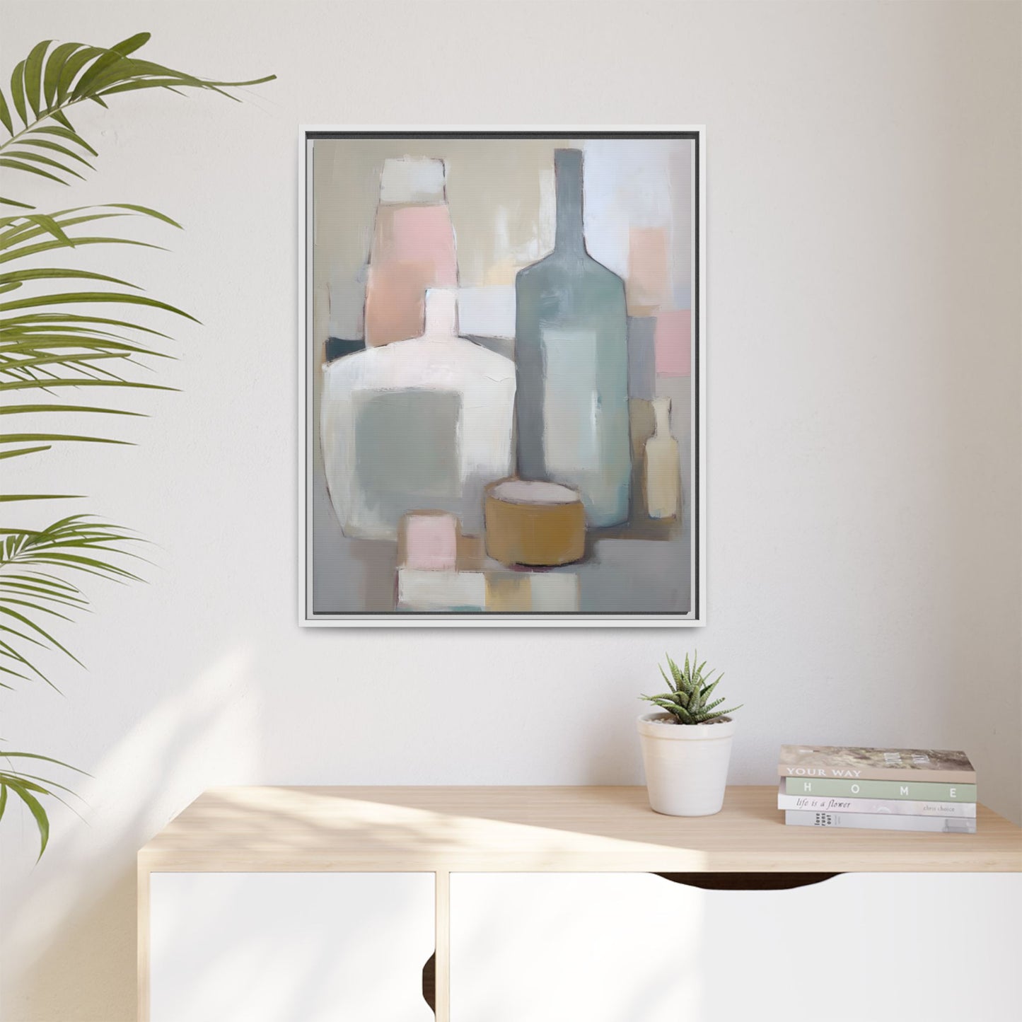 Modern Abstract Bottle Still Life Wall Art – Framed Canvas in Soft Pink, Blue, and Beige hanging on a wall with plant decor.