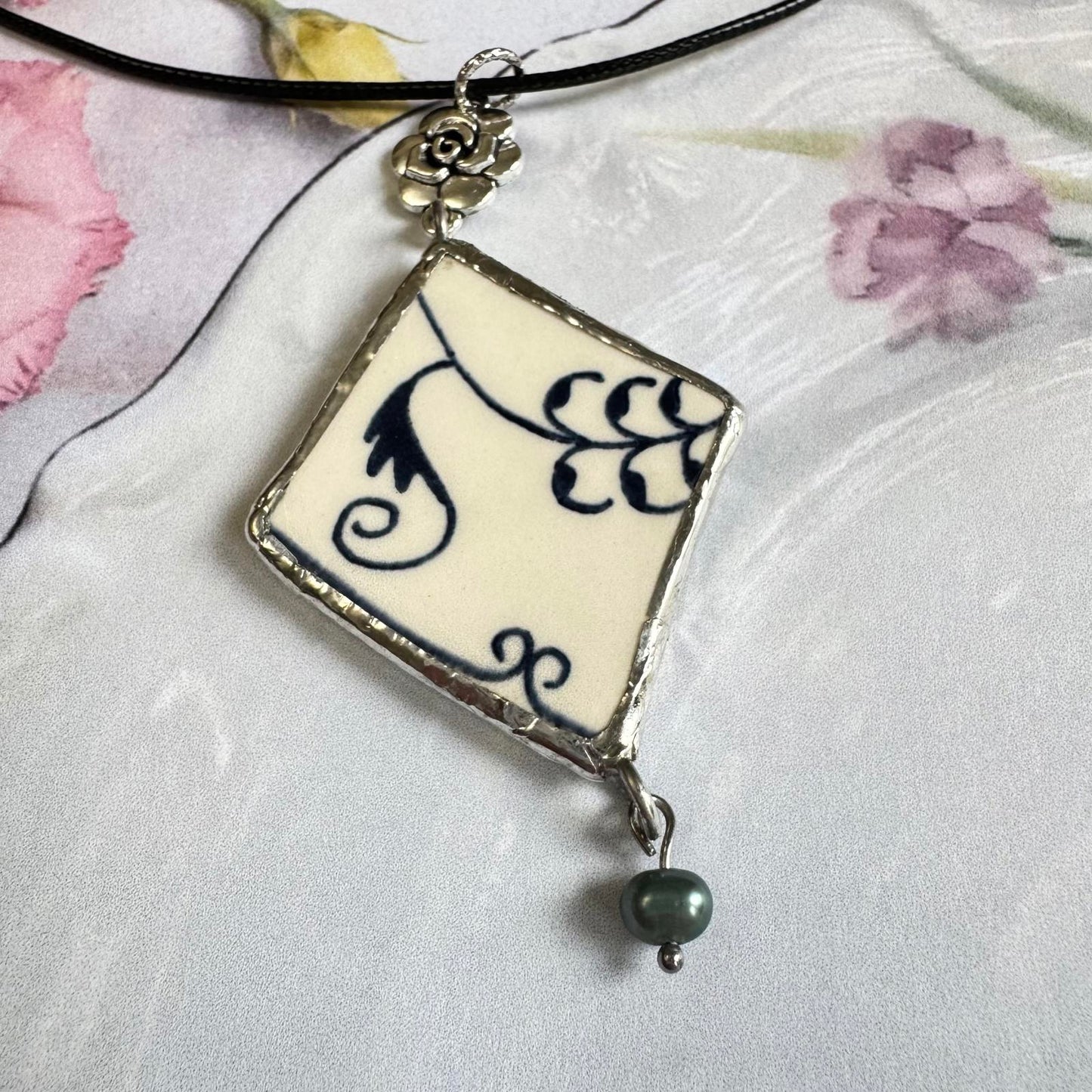 Handmade Broken China Pendant Necklace – Blue Floral Scroll, Rose Charm with pearl bead on black cord.