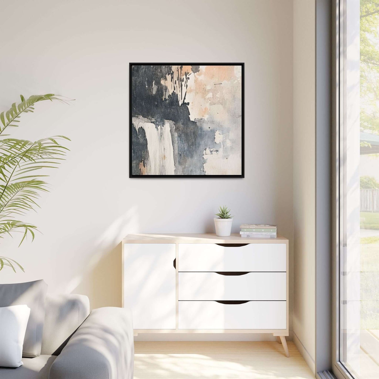 Framed waterfall art print on matte canvas in modern living room decor, featuring a 24x24 inch piece above a white cabinet.