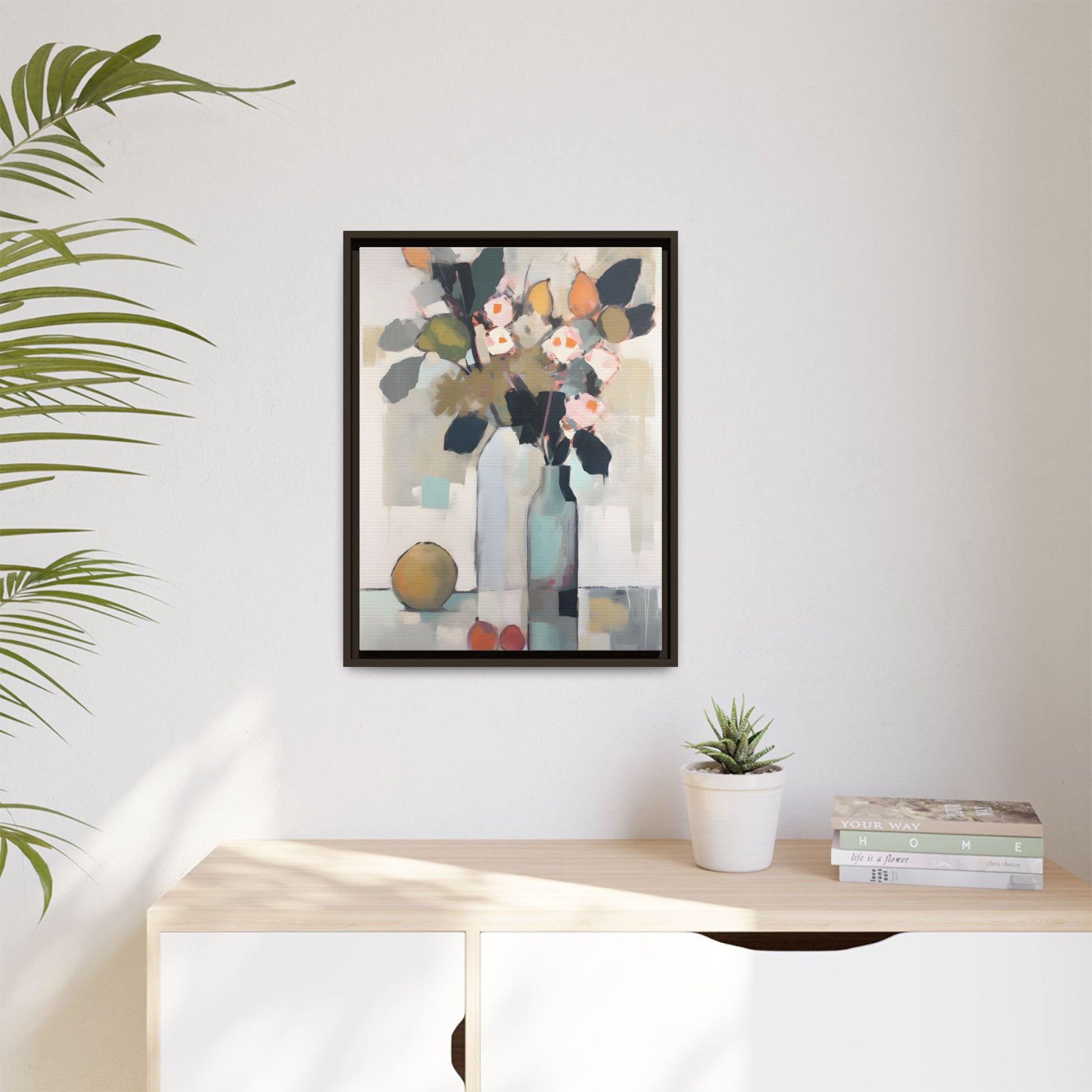 Modern Floral Still Life Wall Art – Framed Canvas with Bold Leaves and Citrus in Vase on display in a contemporary room.