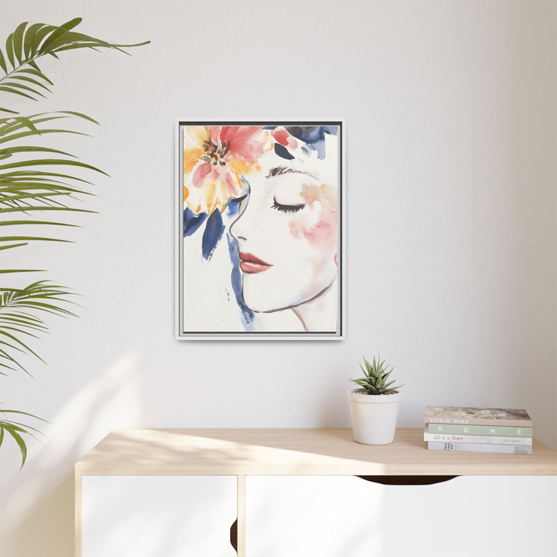 Multi-Color Framed Matte Canvas Art - Floral Face Portrait on wall above shelf with plant and books