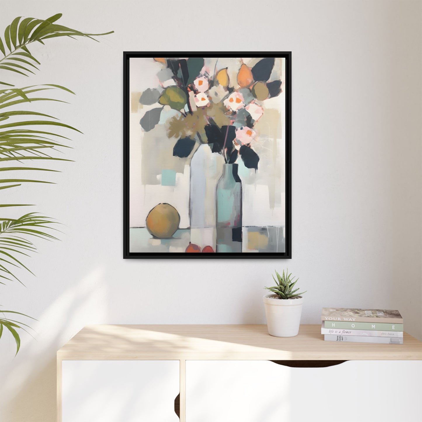 Modern Floral Still Life Wall Art – Framed Canvas with Bold Leaves and Citrus in Vase hanging in a bright, modern room.