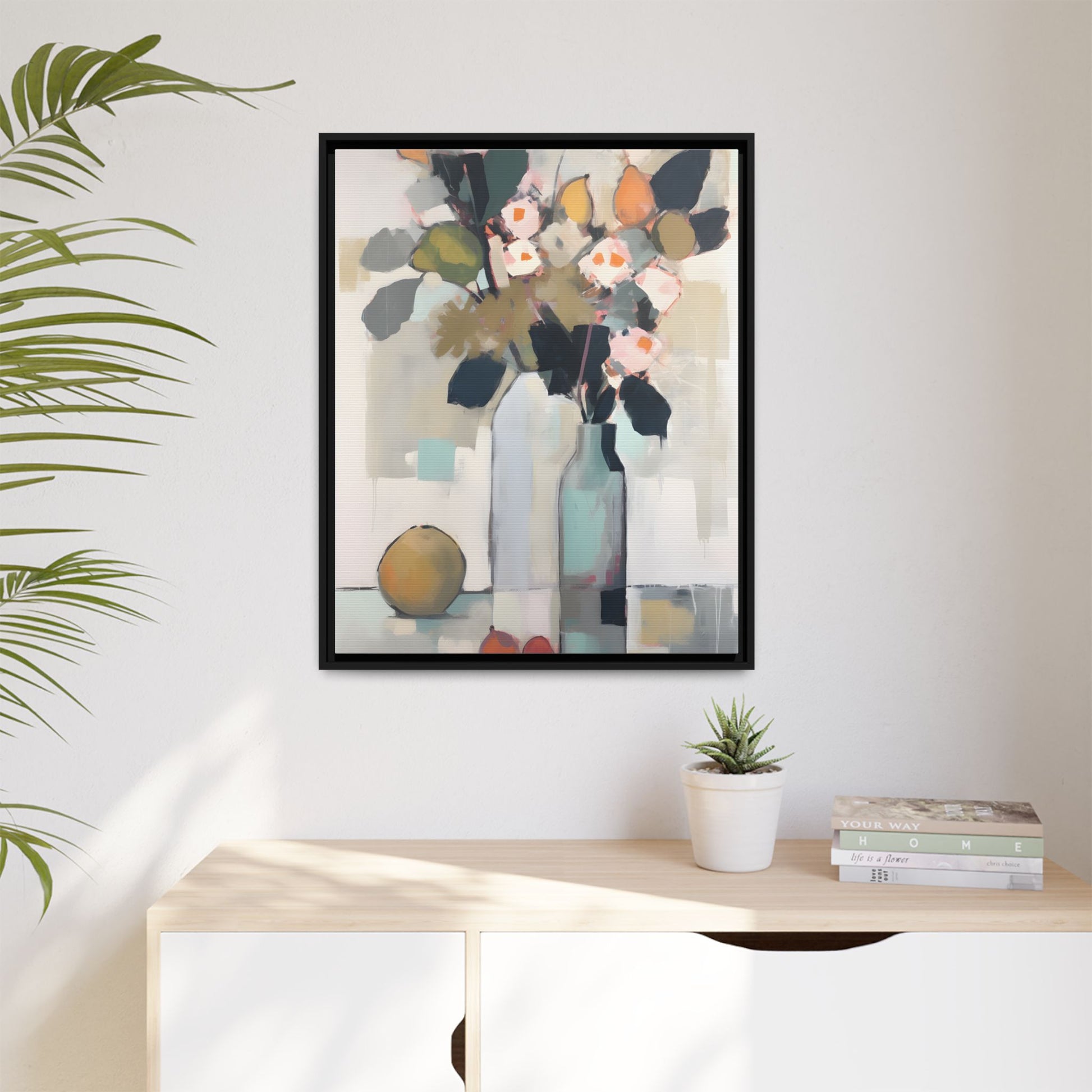 Modern Floral Still Life Wall Art – Framed Canvas with Bold Leaves and Citrus in Vase hanging in a bright, modern room.