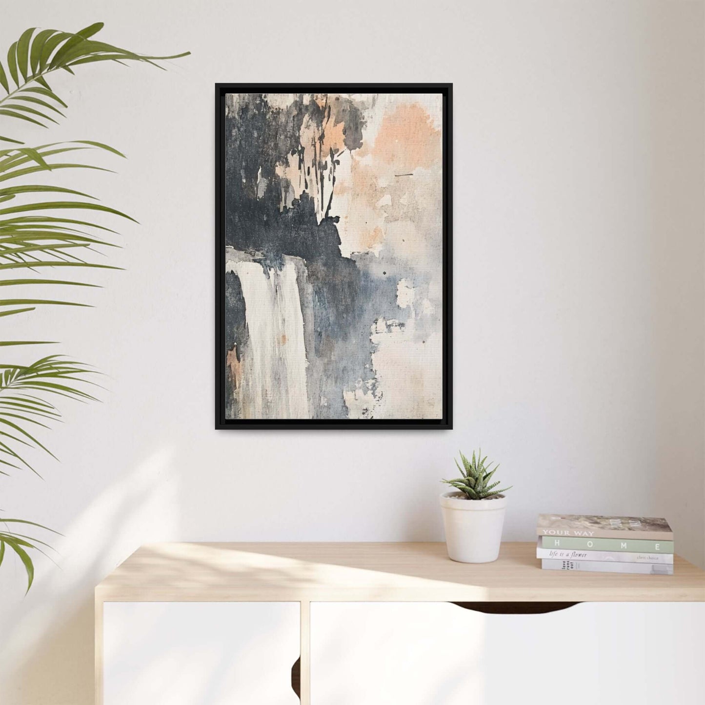 Framed waterfall art print on matte canvas, 9x12 inches, displayed in modern home decor setting with plant and books.