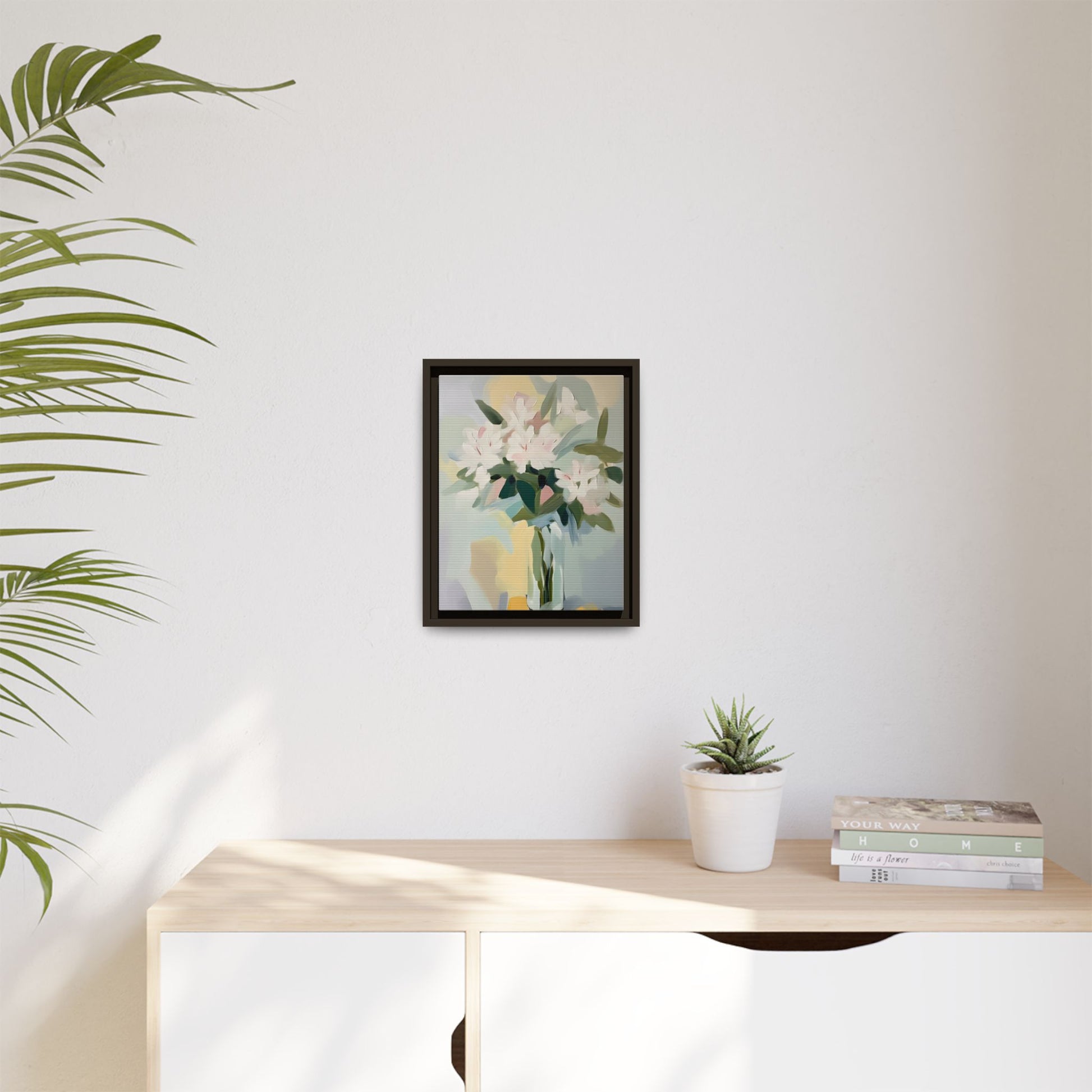 Soft Abstract Floral Wall Art – Framed Modern Canvas with White Flowers in Green Vase in room with plant and books