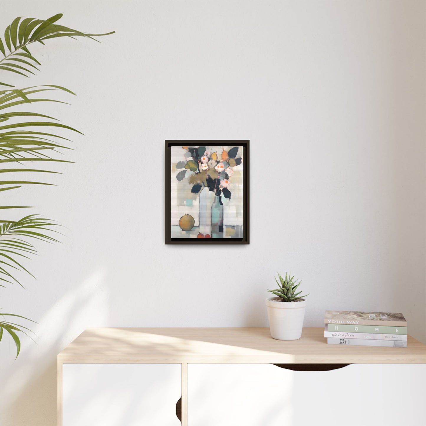 Modern Floral Still Life Wall Art – Framed Canvas with Bold Leaves and Citrus in Vase displayed in a bright minimalist room