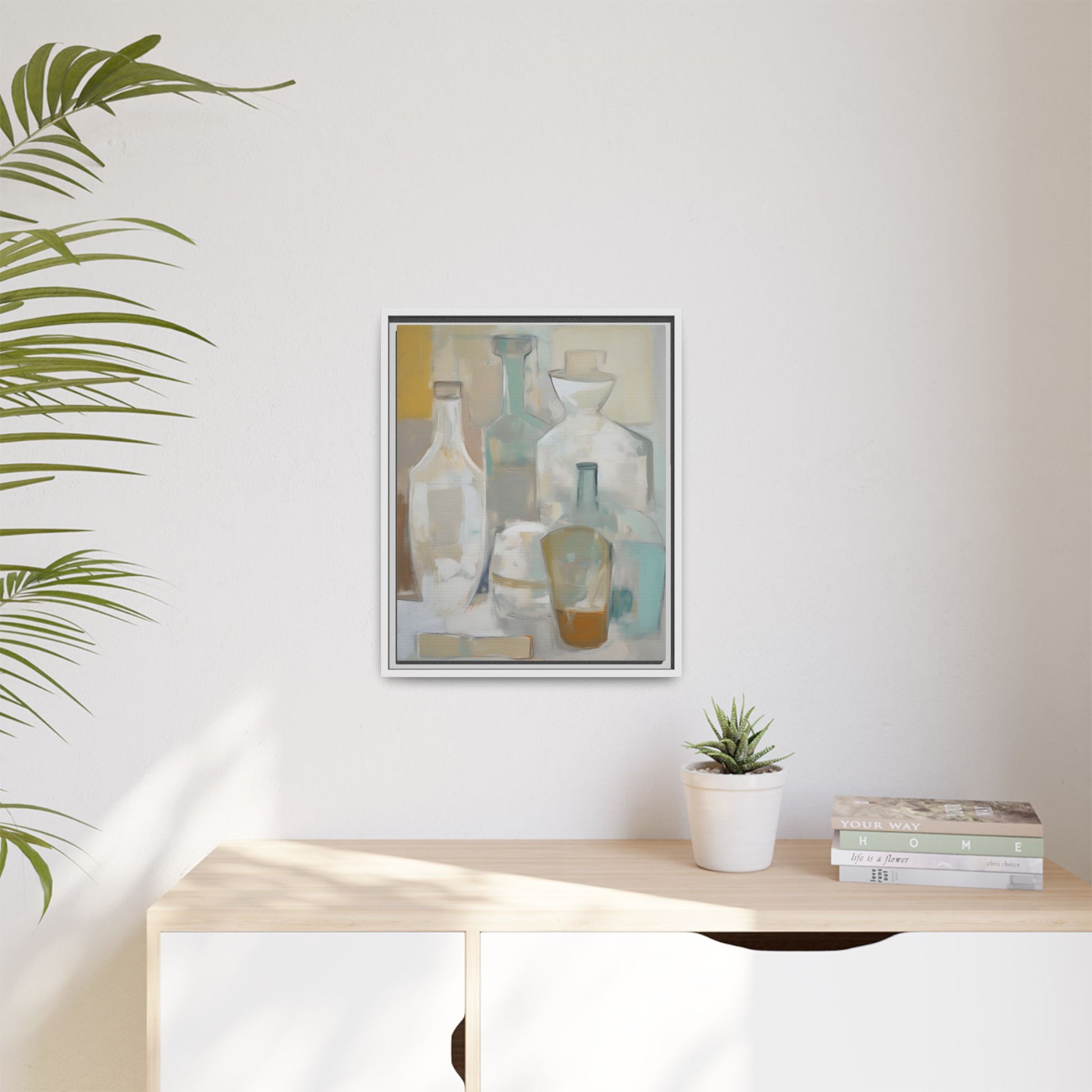 Modern Still Life Wall Art – Neutral Bottles Framed Canvas in Beige, Aqua & Amber hanging in a minimalist room with plant decor.
