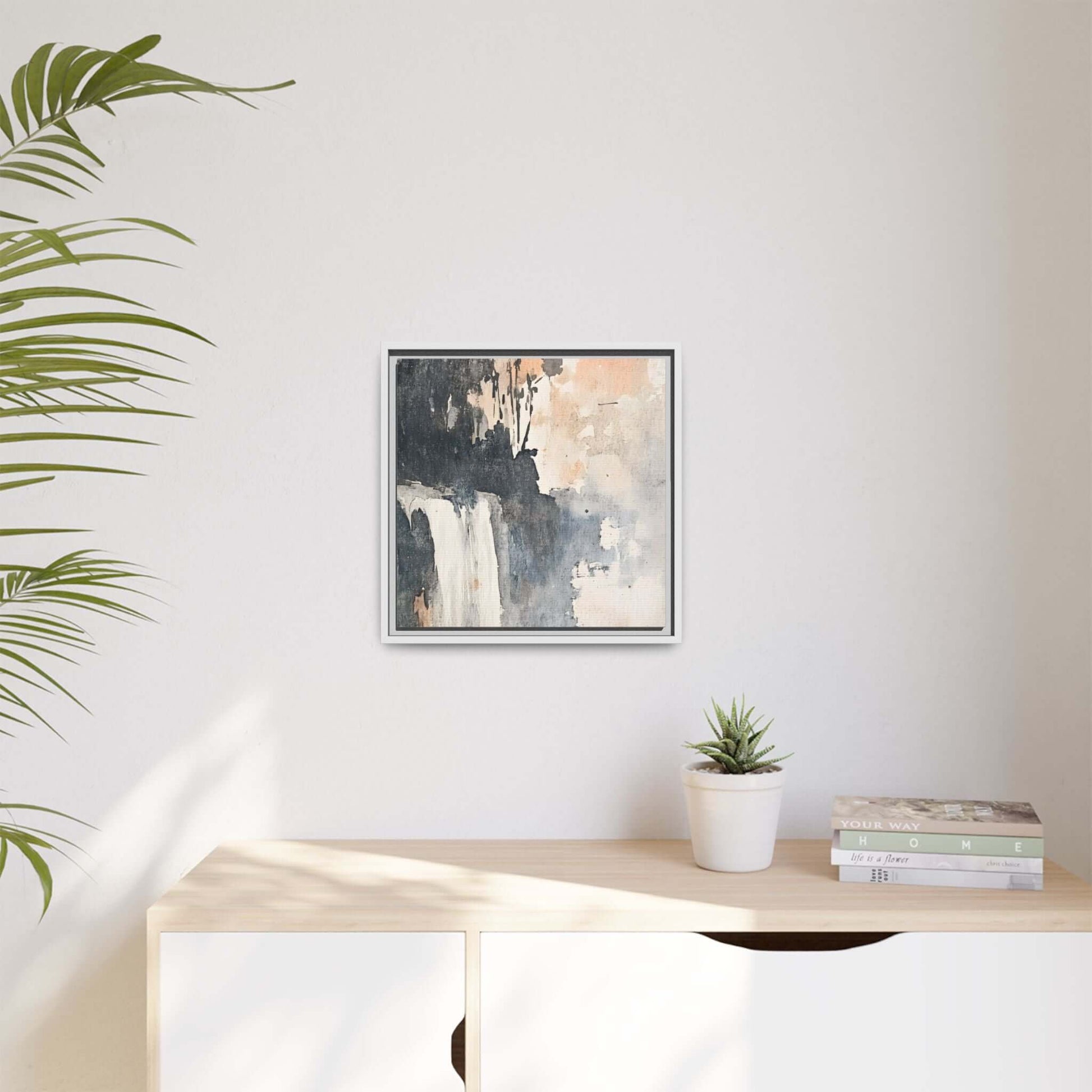 Framed waterfall art print on matte canvas hanging in a modern living room. Home decor accent with earthy tones and elegant design.