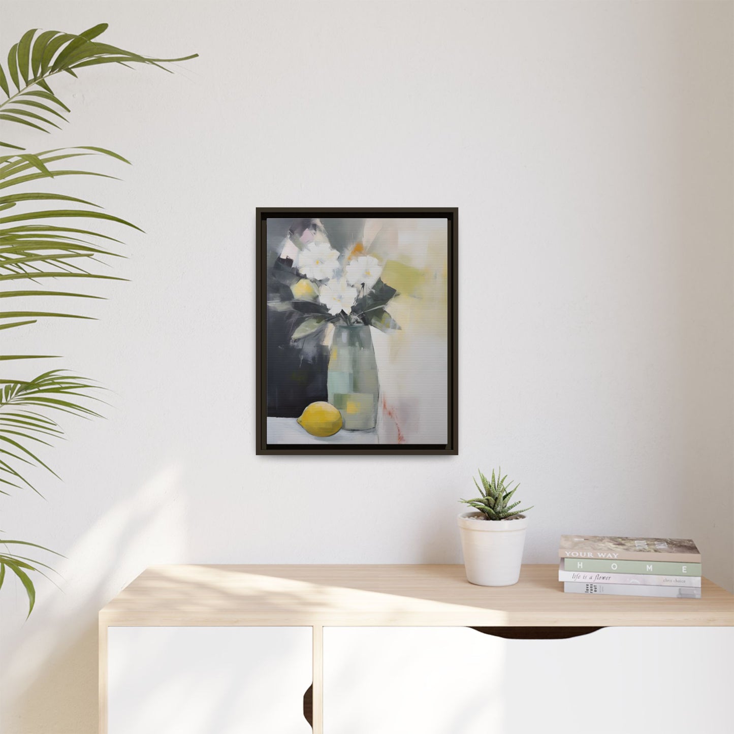 Modern Floral Still Life Wall Art – Framed Canvas with White Flowers and Lemon in Soft Green Vase on display in a bright room.
