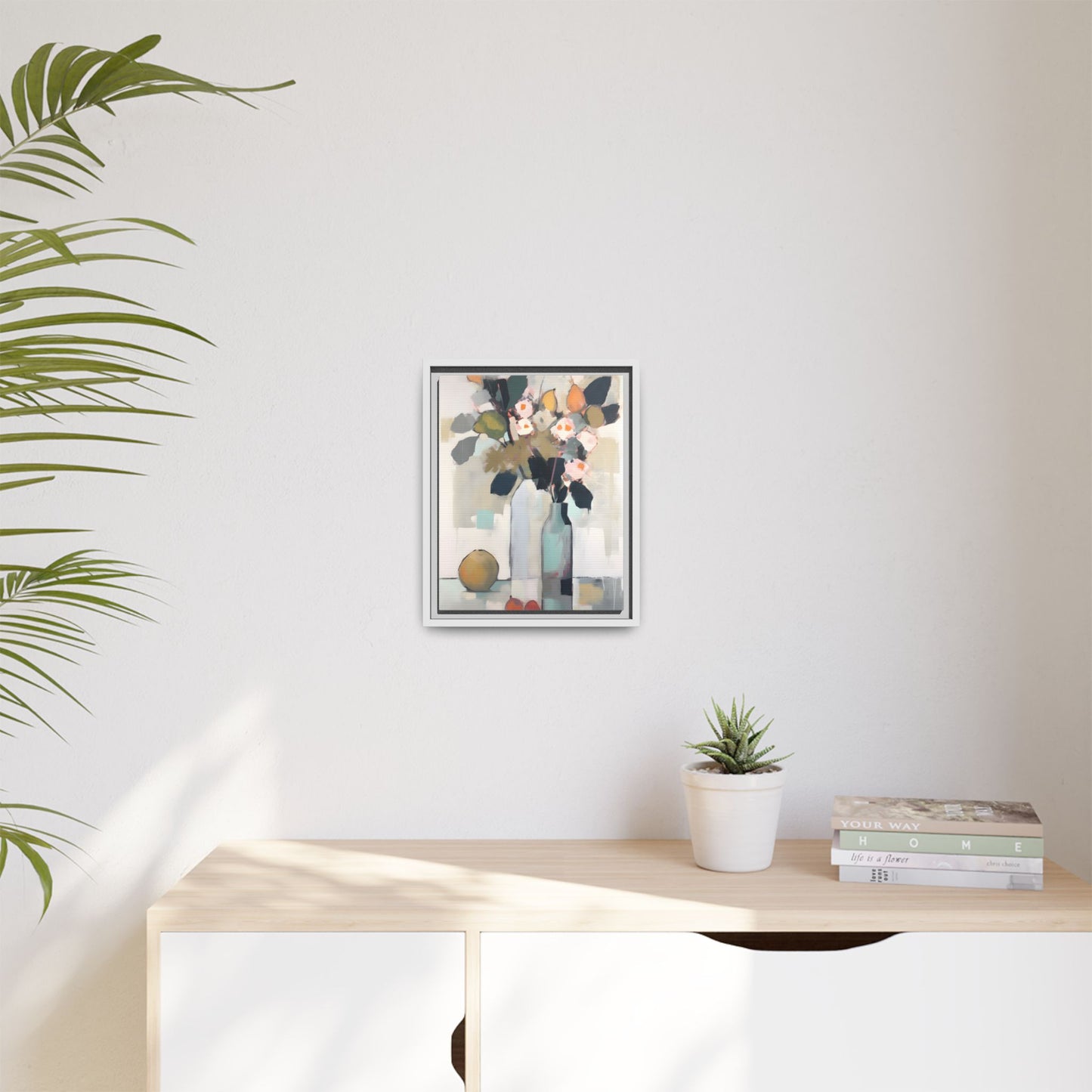 Modern Floral Still Life Wall Art – Framed Canvas with Bold Leaves and Citrus in Vase; abstract artwork decor in room setting.