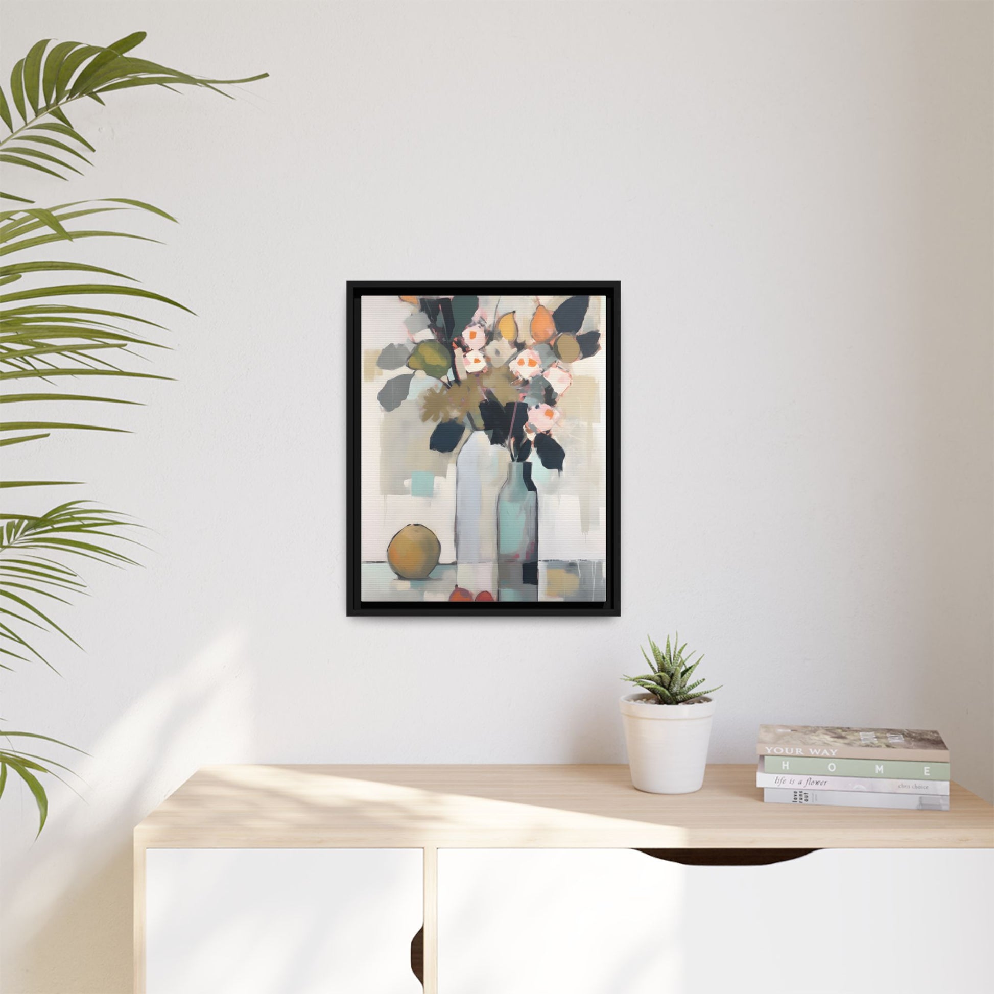 Modern Floral Still Life Wall Art – Framed Canvas with Bold Leaves and Citrus in Vase on wall above desk in bright room.