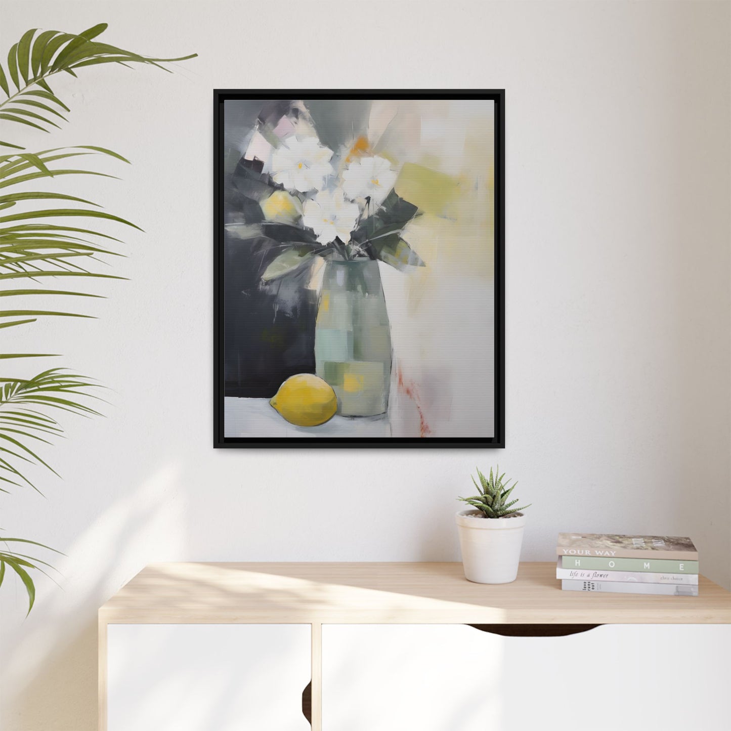Modern Floral Still Life Wall Art – Framed Canvas with White Flowers and Lemon in Soft Green Vase on wall above a sideboard with decor