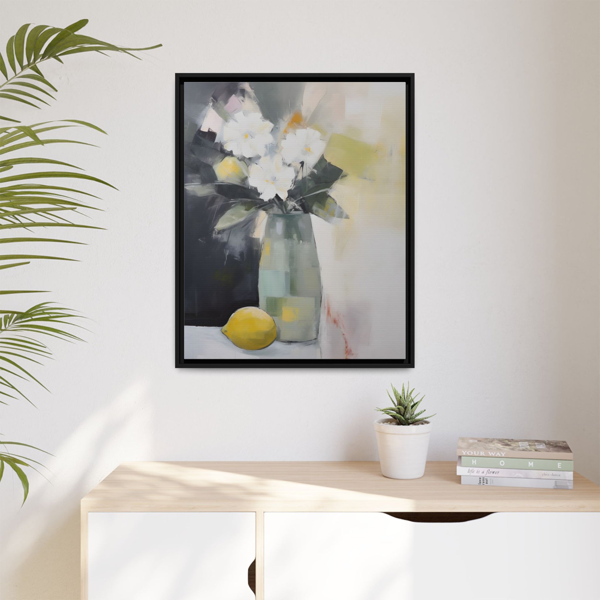 Modern Floral Still Life Wall Art – Framed Canvas with White Flowers and Lemon in Soft Green Vase on wall above a sideboard with decor