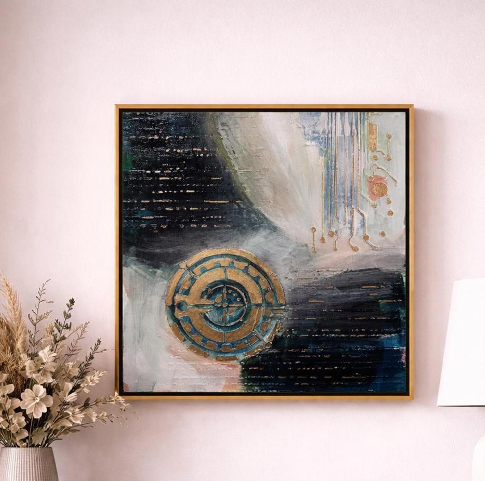 Abstract art piece with a gold circular design on a white wall, flanked by decorative elements.