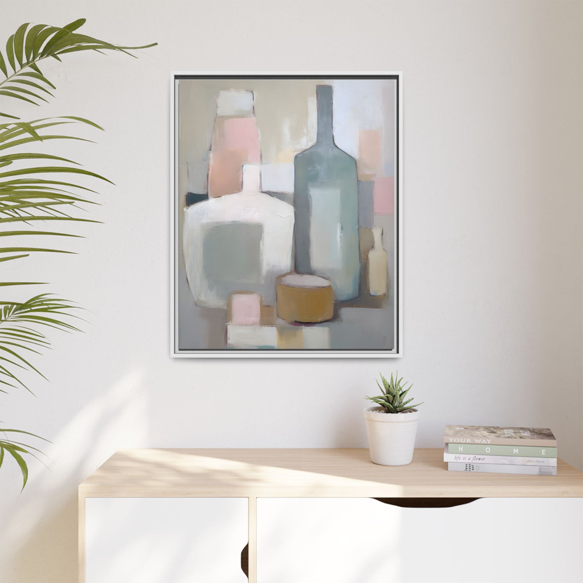 Modern Abstract Bottle Still Life Wall Art – Framed Canvas in Soft Pink, Blue, and Beige hanging on a wall with plant decor.