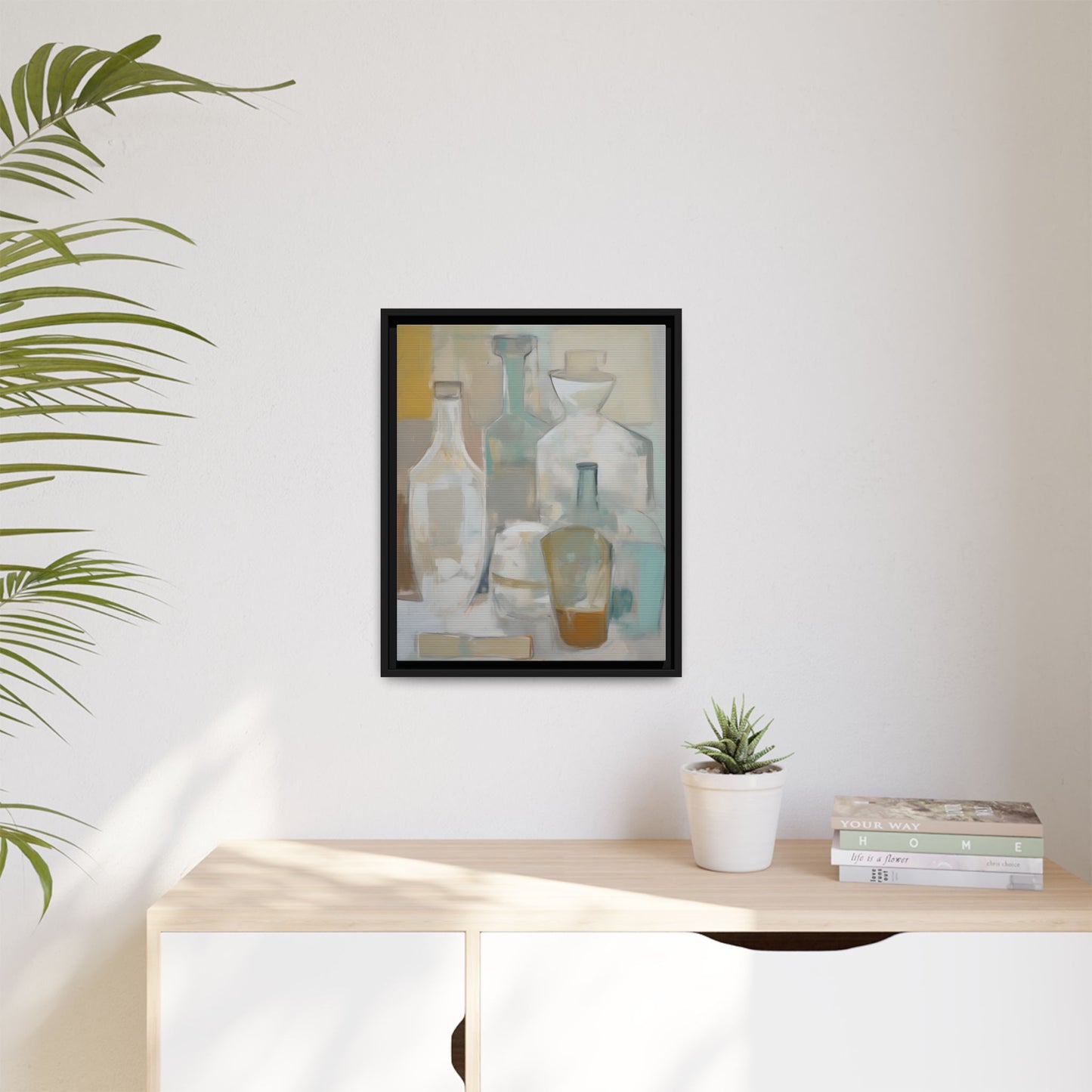 Modern Still Life Wall Art – Neutral Bottles Framed Canvas in Beige, Aqua & Amber on a white wall above a wooden sideboard.