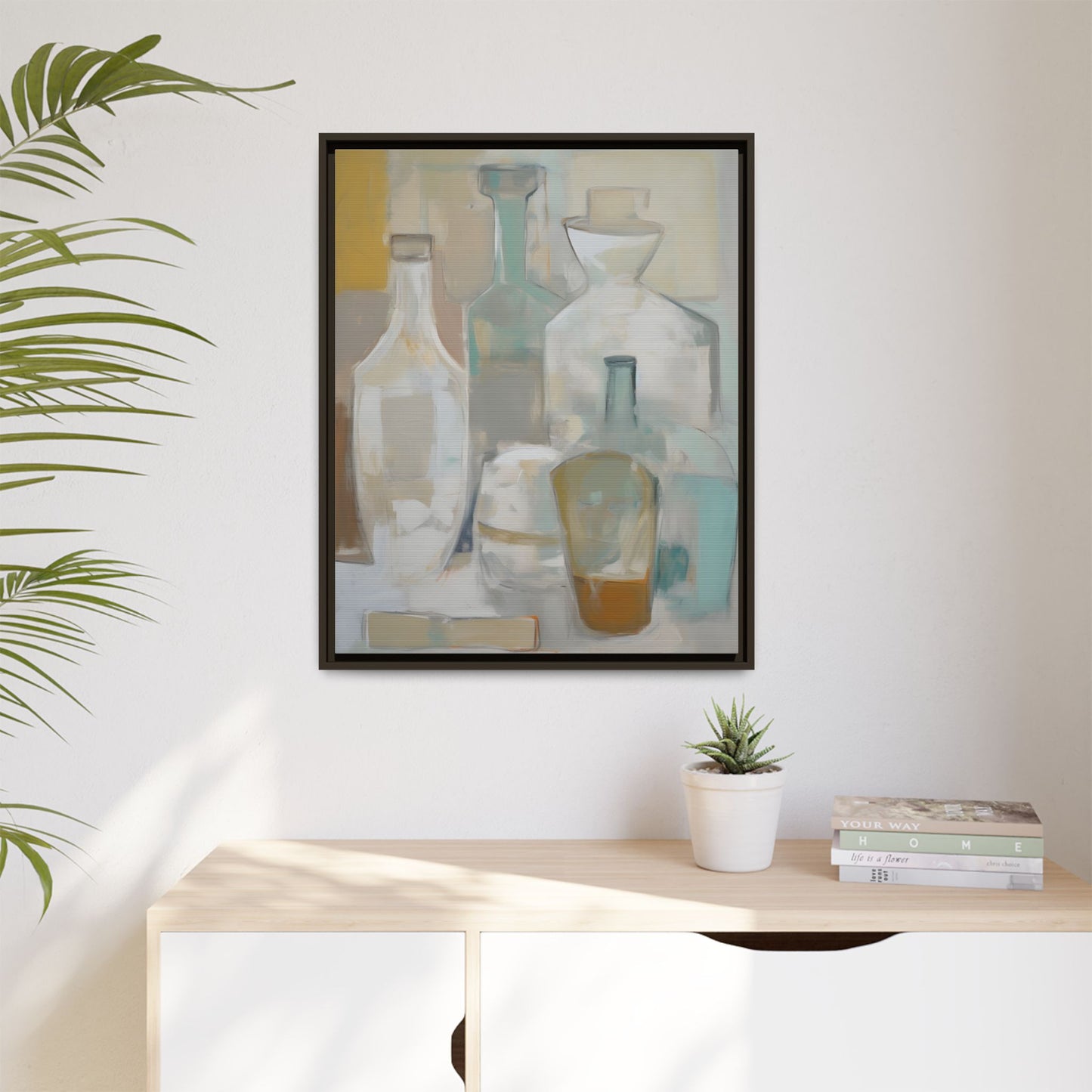 Modern Still Life Wall Art – Neutral Bottles Framed Canvas in Beige, Aqua & Amber hanging in a minimalist interior with greenery.