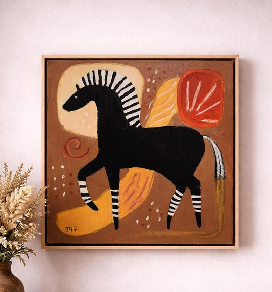Framed artwork of a stylized zebra on a brown background, displayed on a wall.