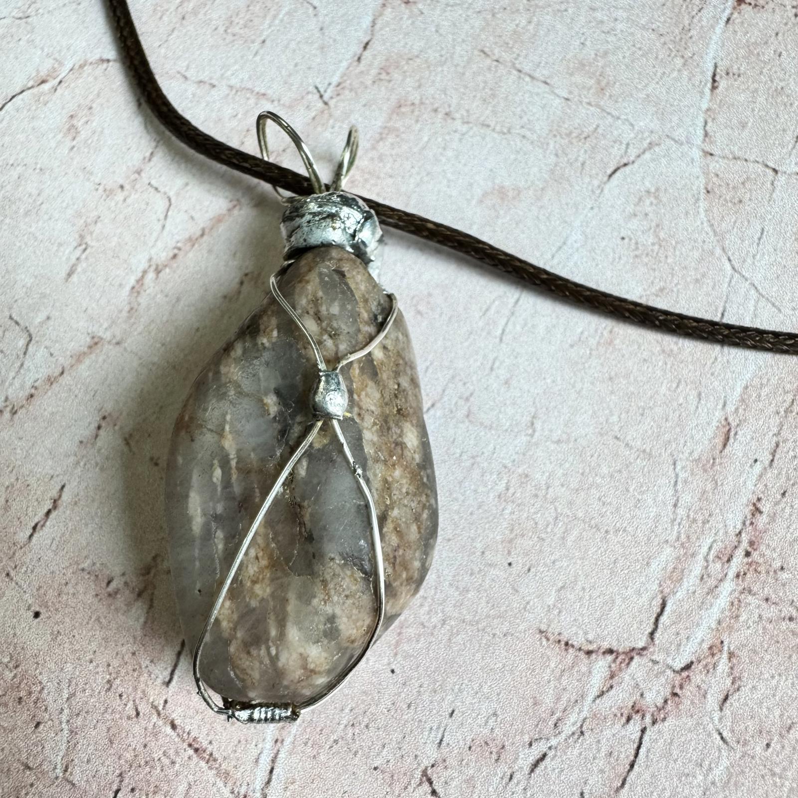 Handcrafted Natural Smokey Quarts Stone Pendant Necklace Boho with silver wire wrapping on textured background