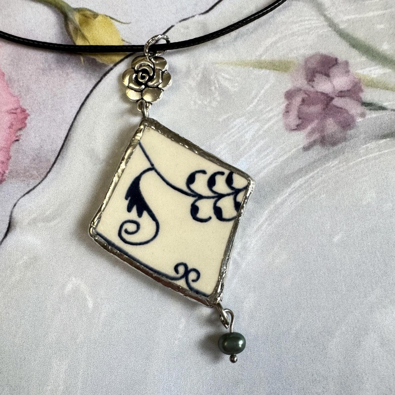 Handmade Broken China Pendant Necklace – Blue Floral Scroll, Rose Charm with dangling freshwater pearl on black cord.
