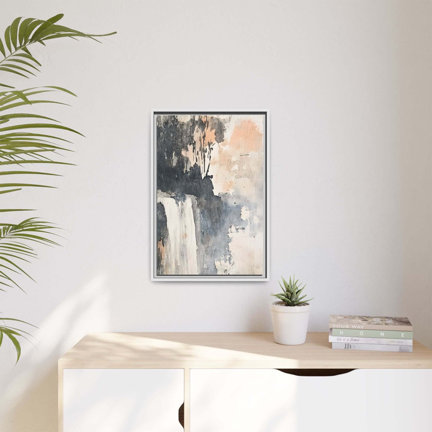 Framed waterfall art print on matte canvas hanging in a modern room with plants and books, natural light enhancing the decor.