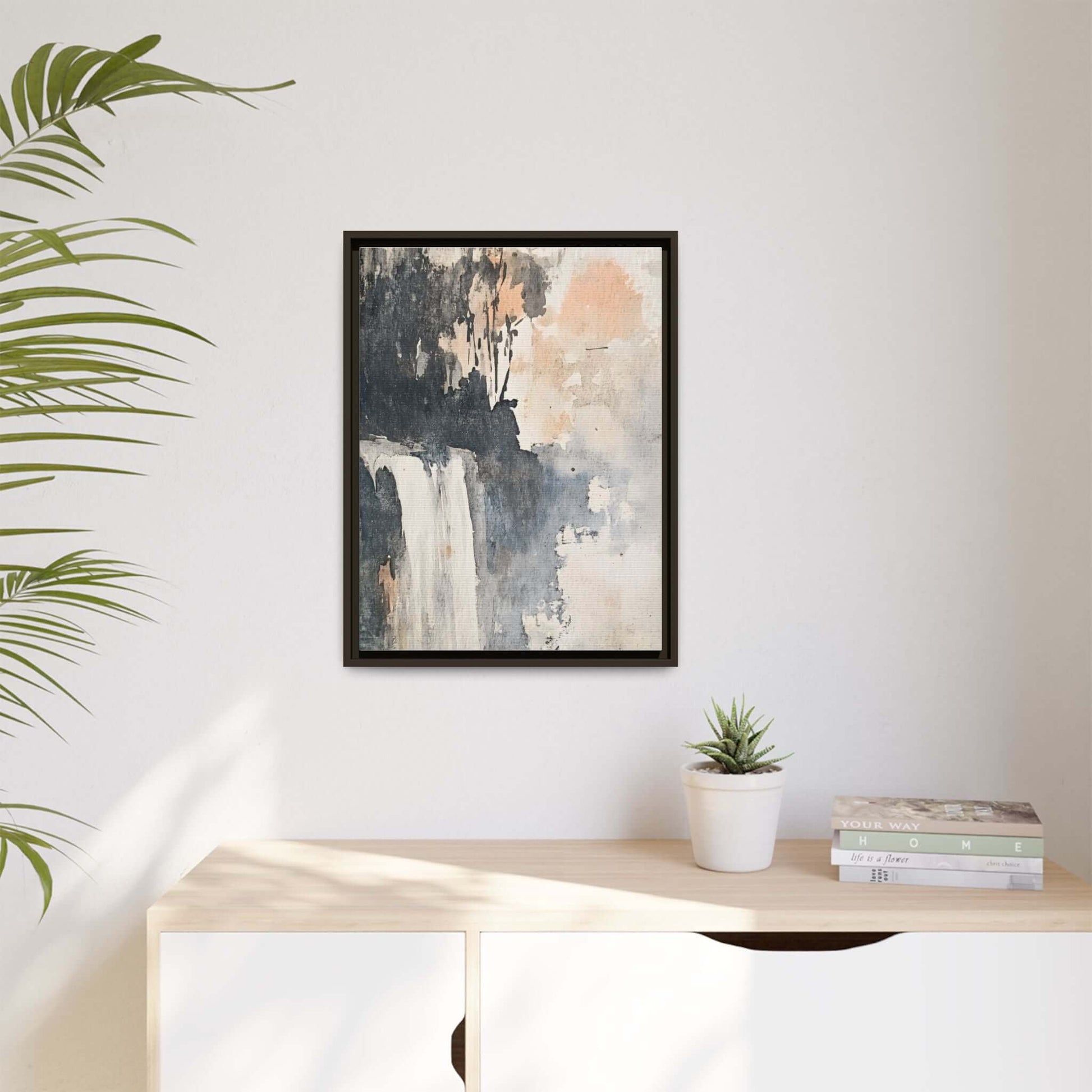 Framed waterfall art print on matte canvas displayed on a modern home decor wall.