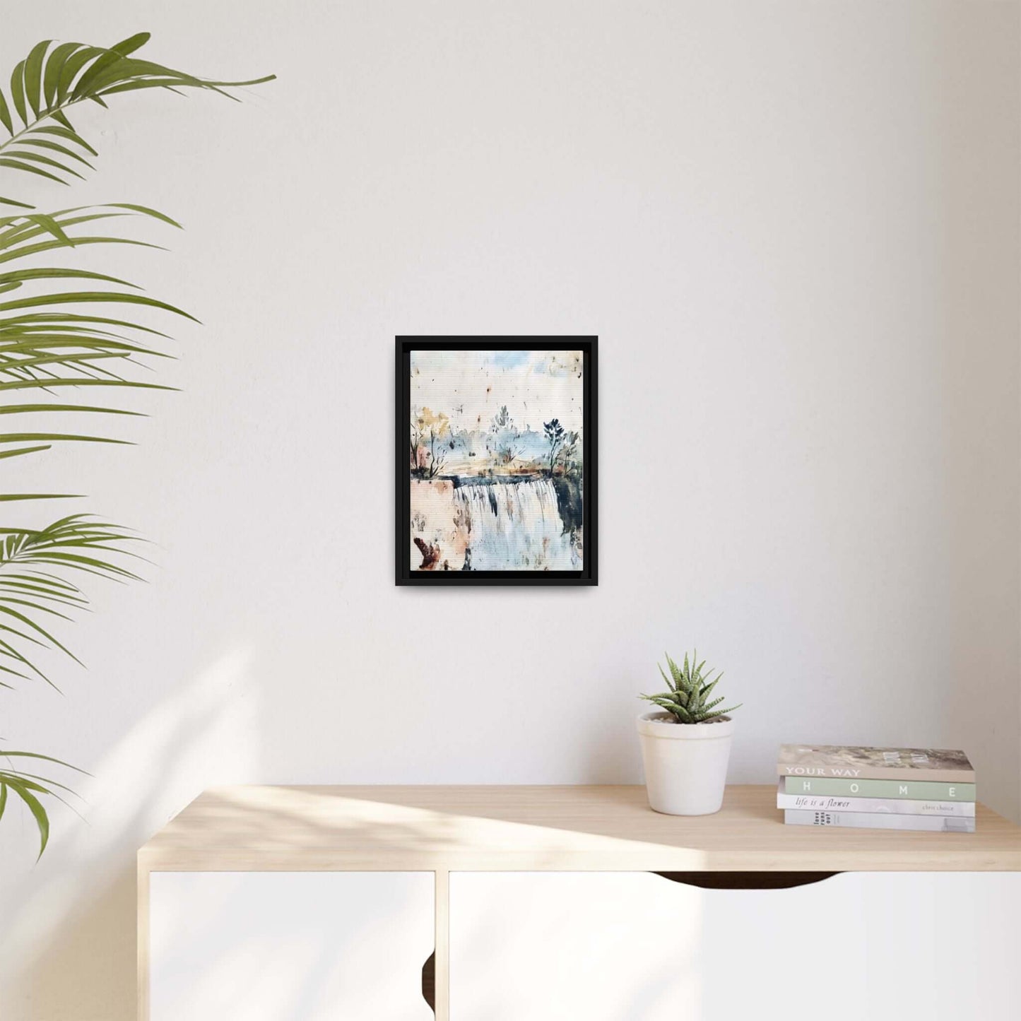 Framed watercolor wall art depicting a serene landscape, displayed in a modern living room, enhancing the minimalist decor.