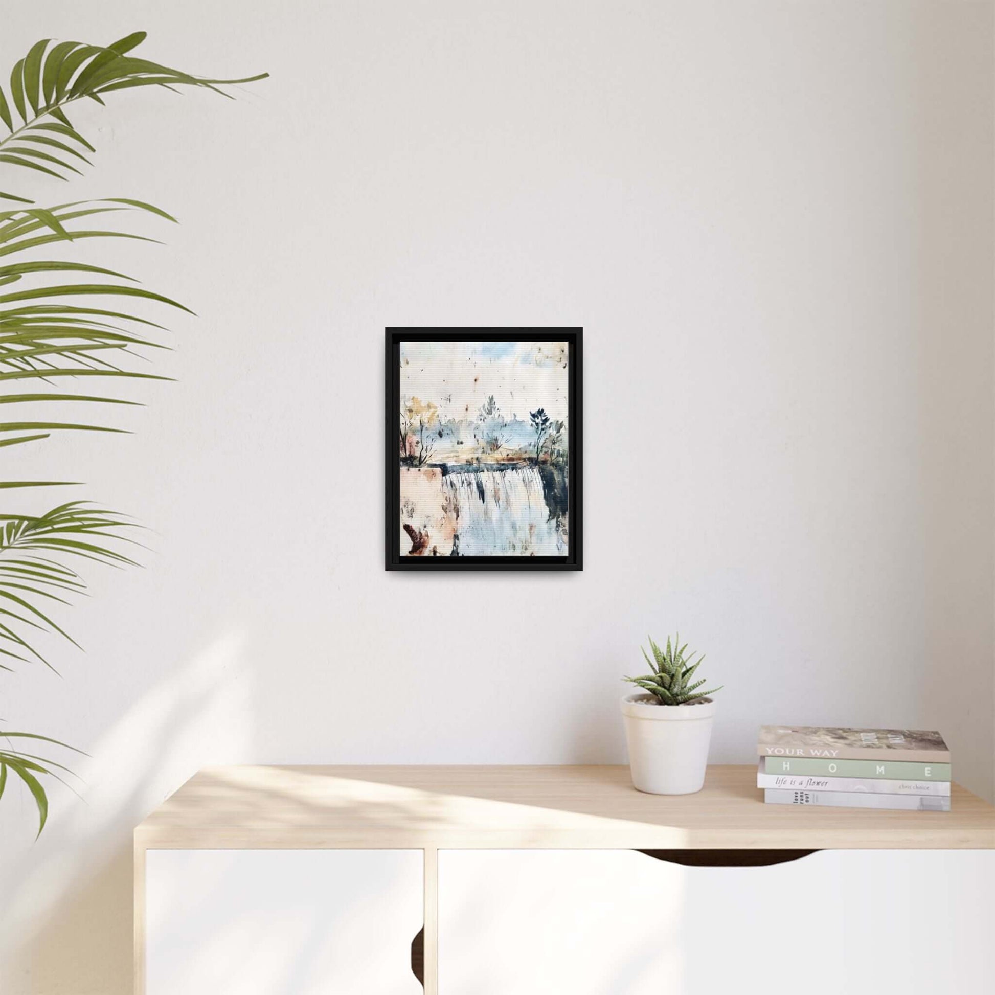 Framed watercolor wall art depicting a serene landscape, displayed in a modern living room, enhancing the minimalist decor.