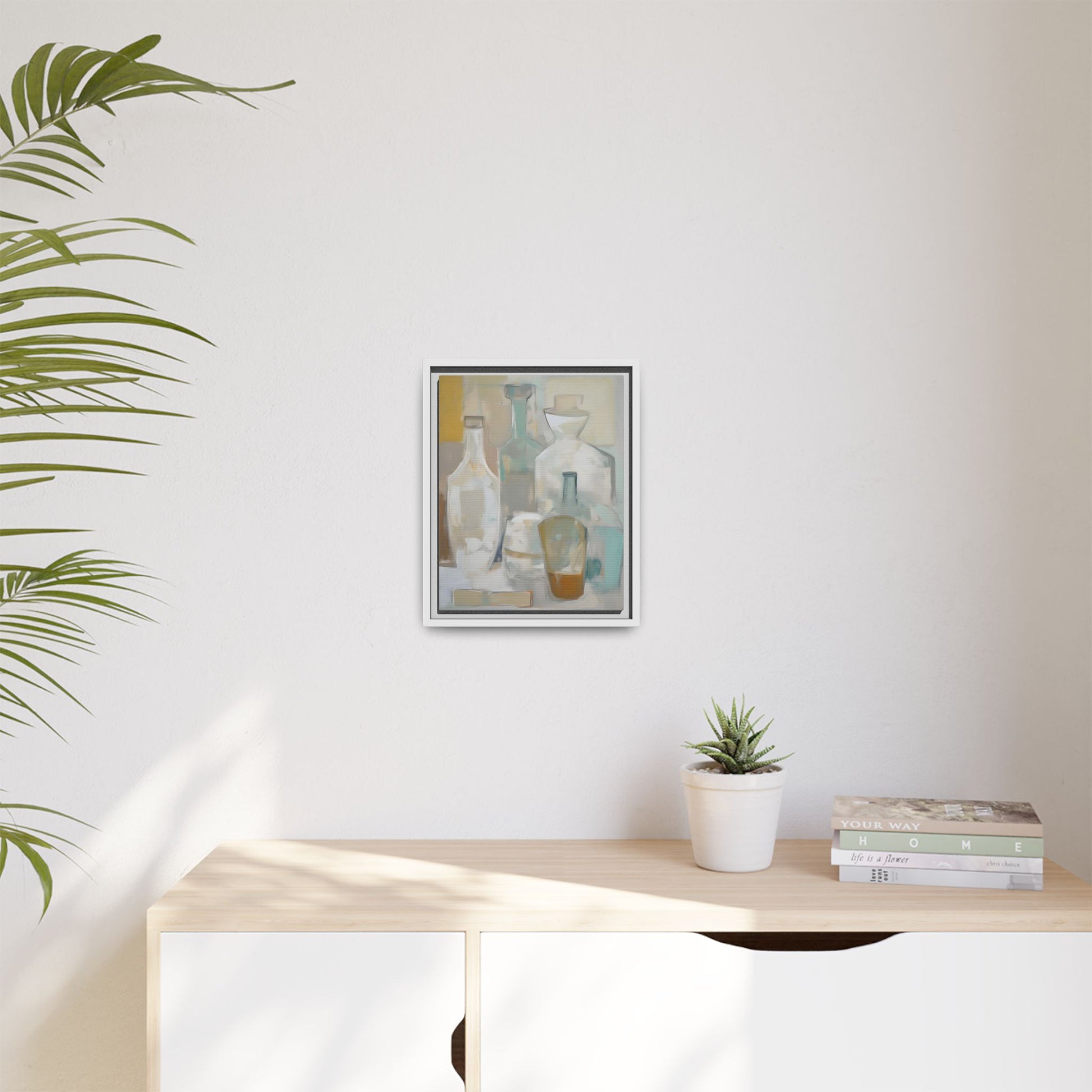 Modern Still Life Wall Art – Neutral Bottles Framed Canvas in Beige, Aqua & Amber displayed in minimalist room with plants and books