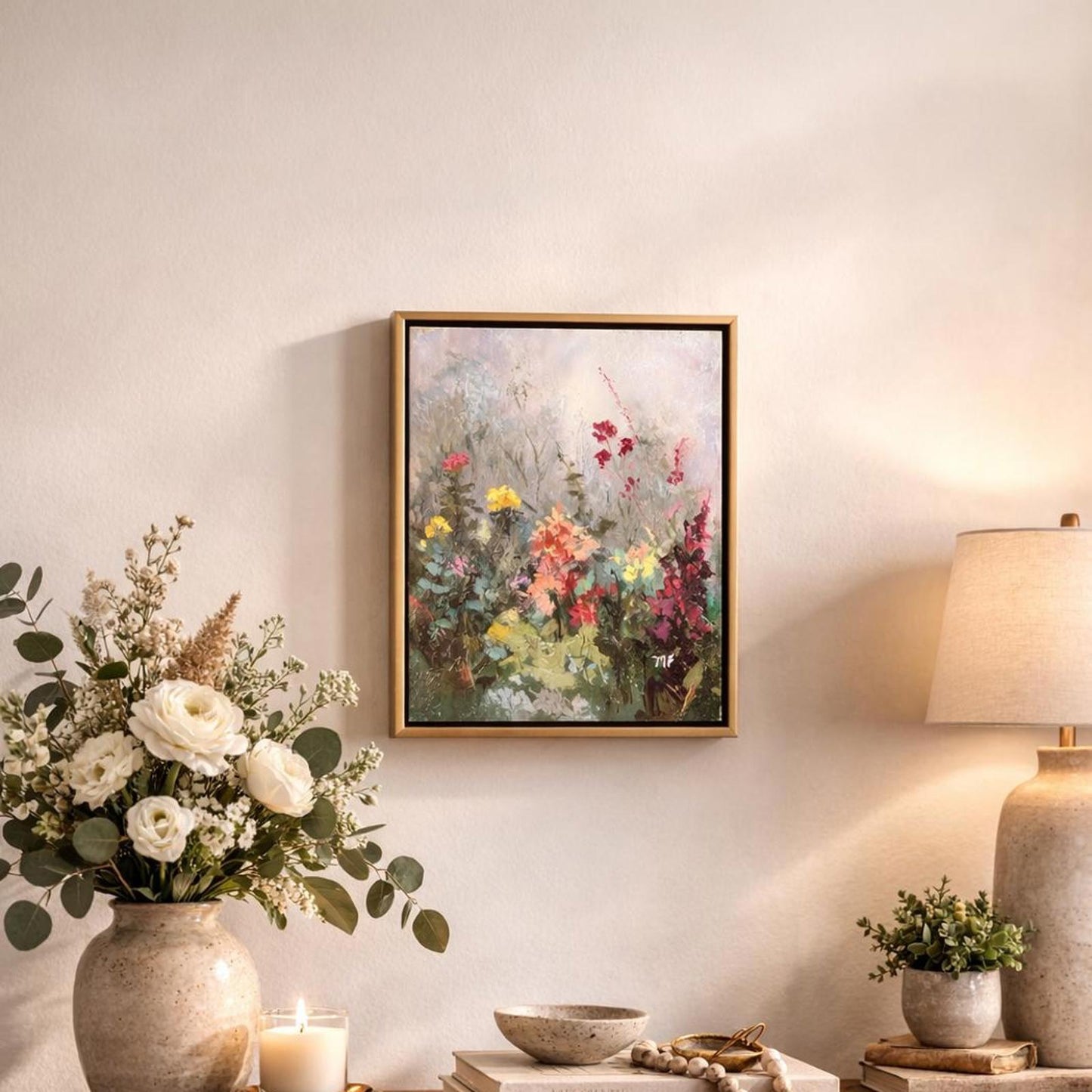 Framed floral painting on a wall with decorative items below