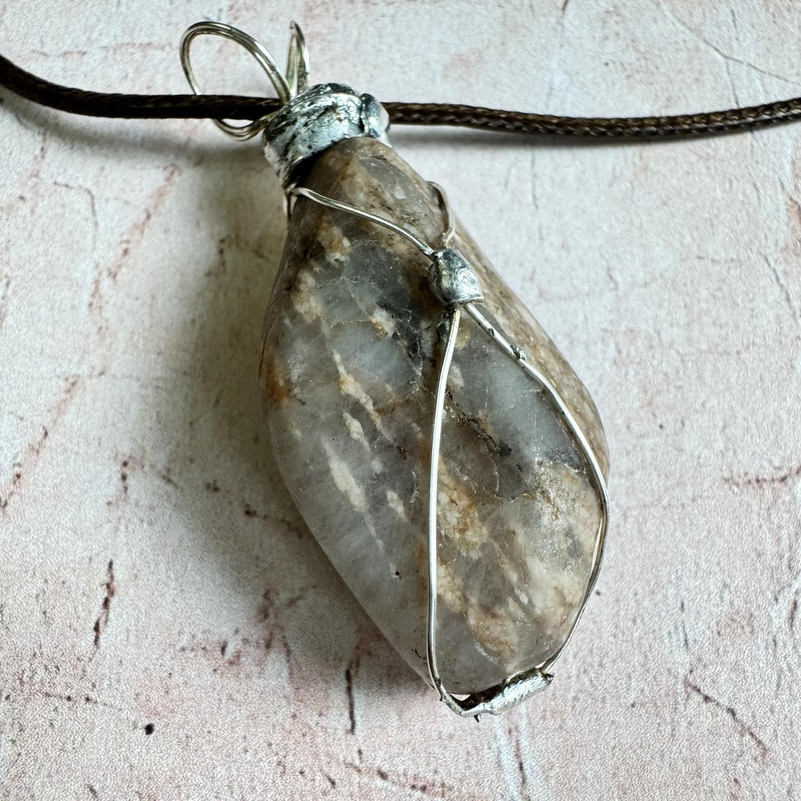 Handcrafted Natural Smokey Quarts Stone Pendant Necklace Boho with silver wire wrapping, showcasing earthy tones on a textured background.