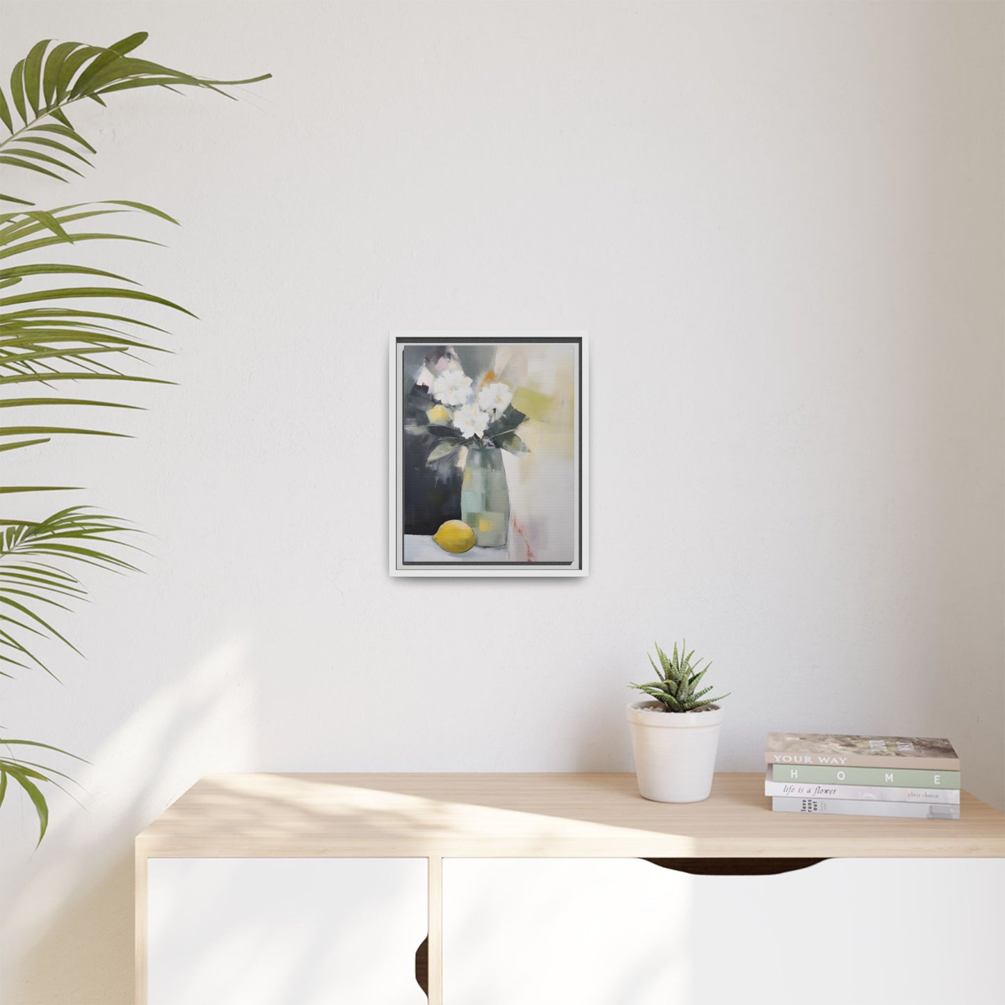 Modern Floral Still Life Wall Art – Framed Canvas with White Flowers and Lemon in Soft Green Vase displayed on a wall.