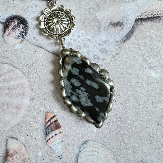 Snowflake Obsidian Stone Pendant Handmade Necklace w/ Silver Tone Floral Accents on beach setting with seashells