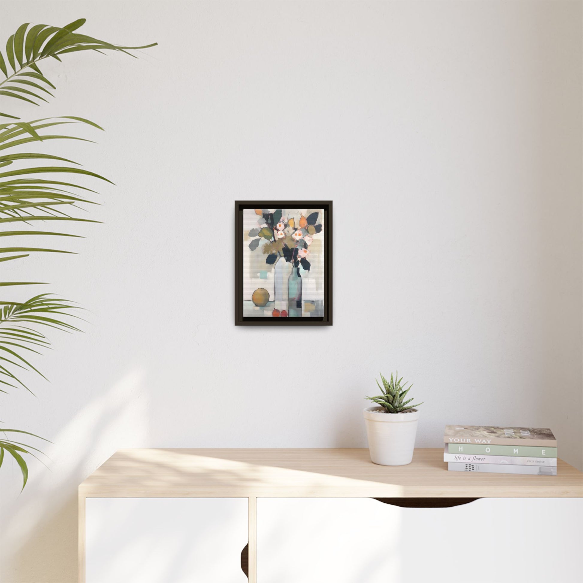 Modern Floral Still Life Wall Art – Framed Canvas with Bold Leaves and Citrus in Vase displayed on a wall above a shelf
