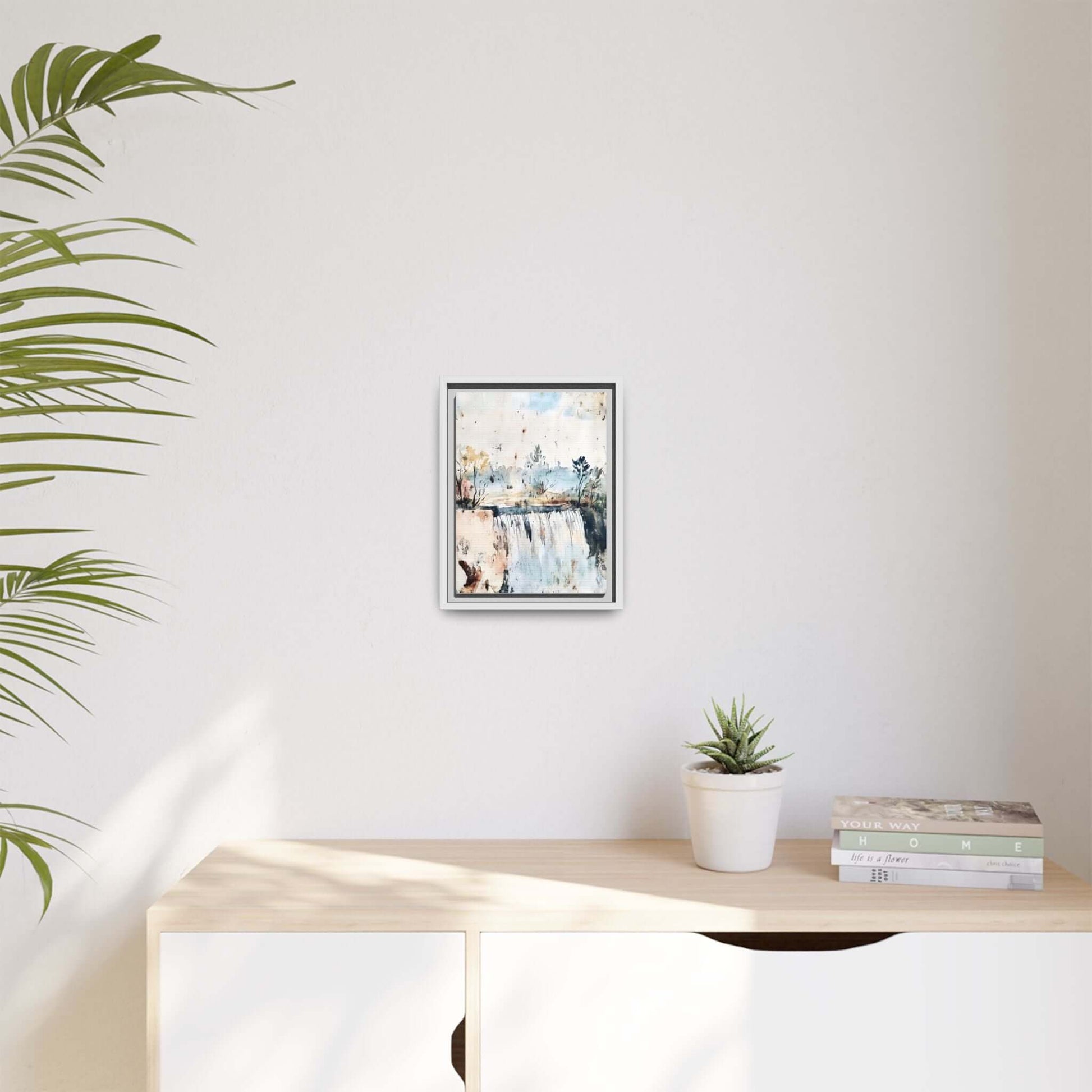Framed watercolor serene landscape wall art on modern shelf, surrounded by plant and books, minimalist home decor.