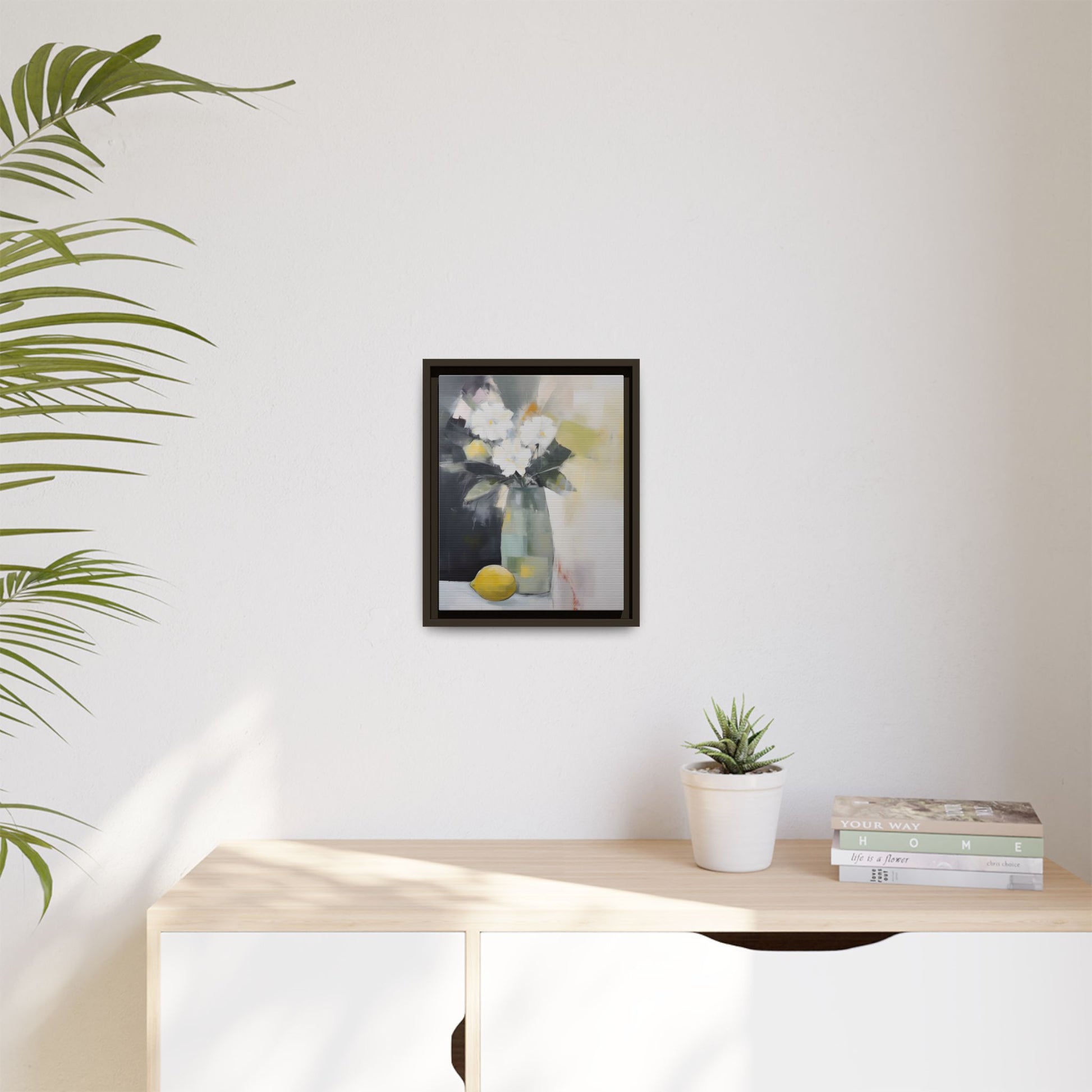 Modern Floral Still Life Wall Art – Framed Canvas with White Flowers and Lemon in Soft Green Vase hanging in a minimalist room