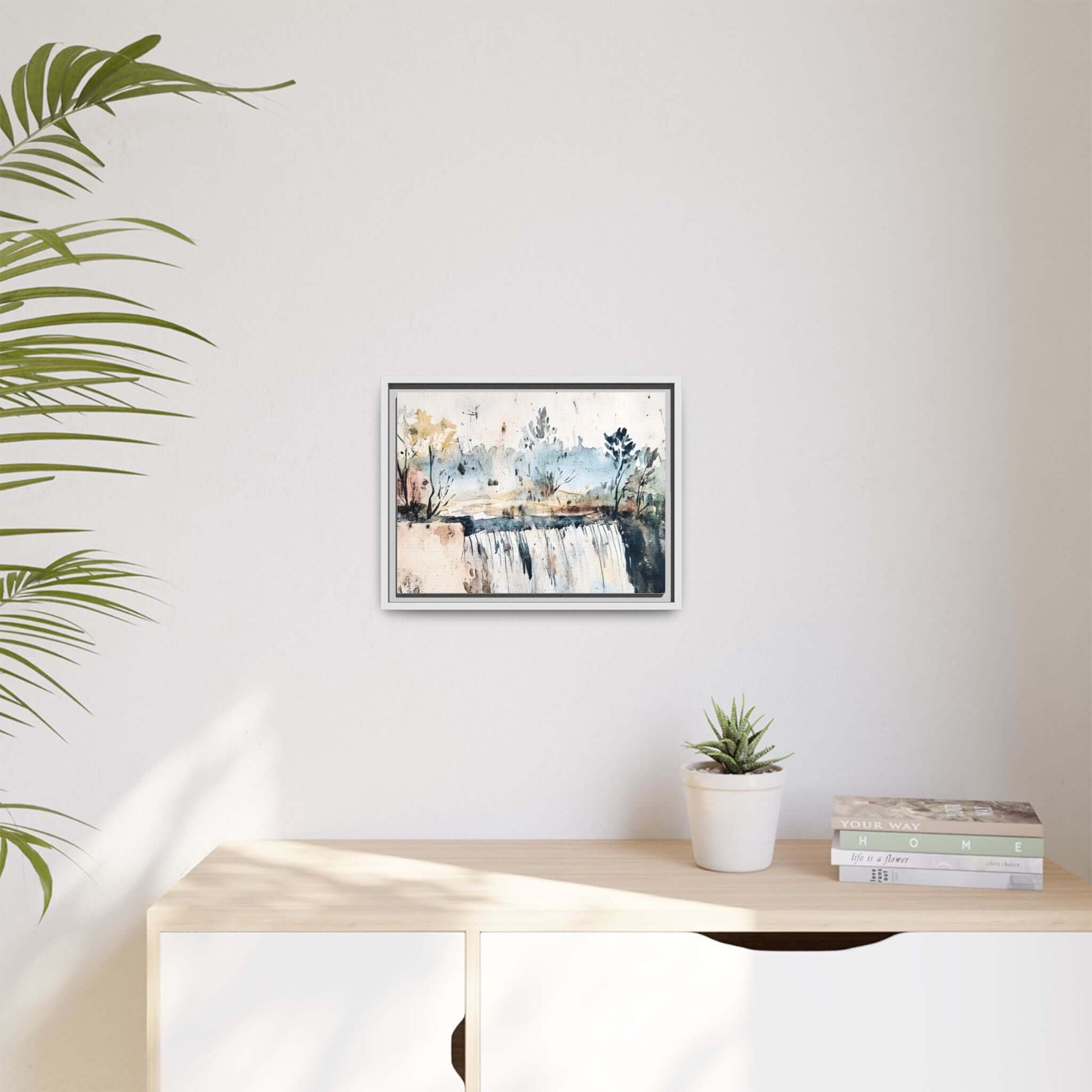 Framed watercolor serene landscape wall art decor displayed above a minimalist cabinet with a plant and books. Art size: 12" x 9".