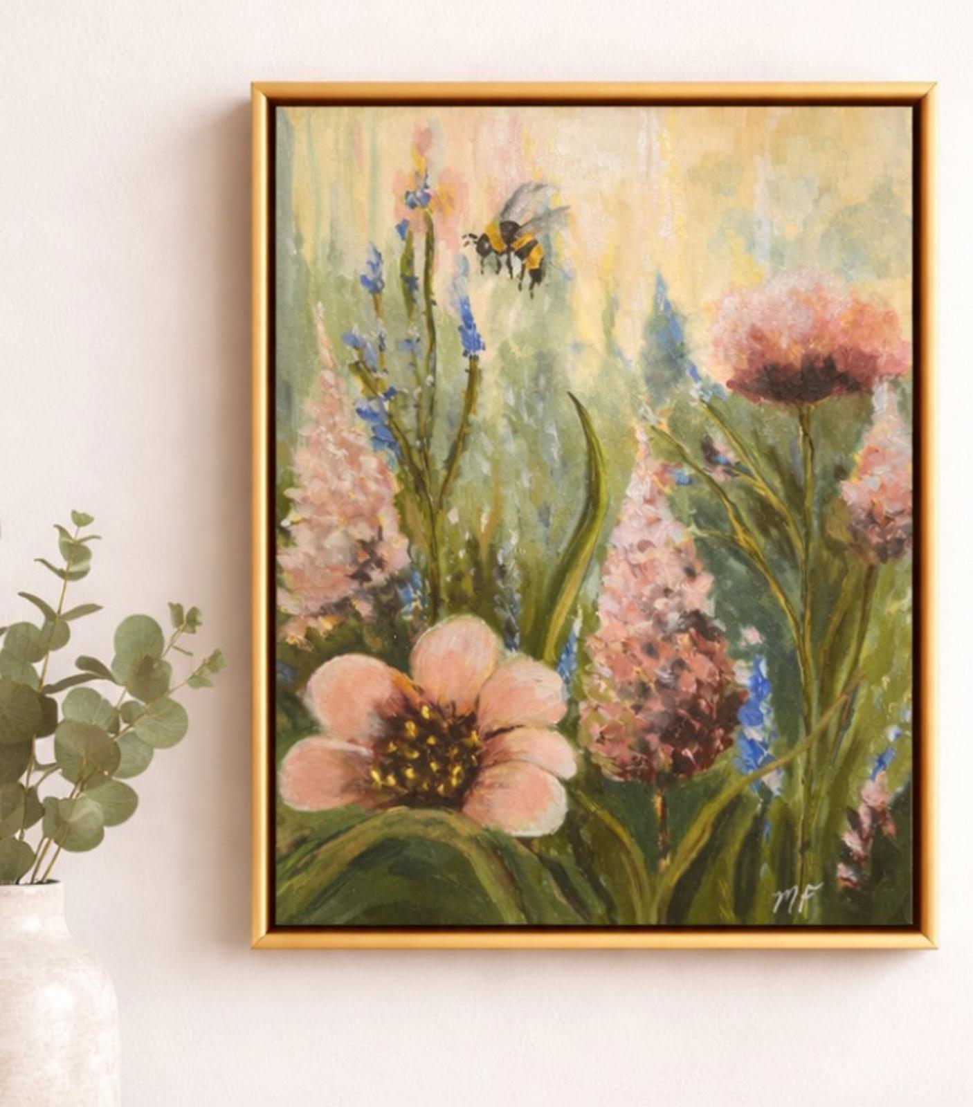 Framed painting of flowers and a bee on a white wall.